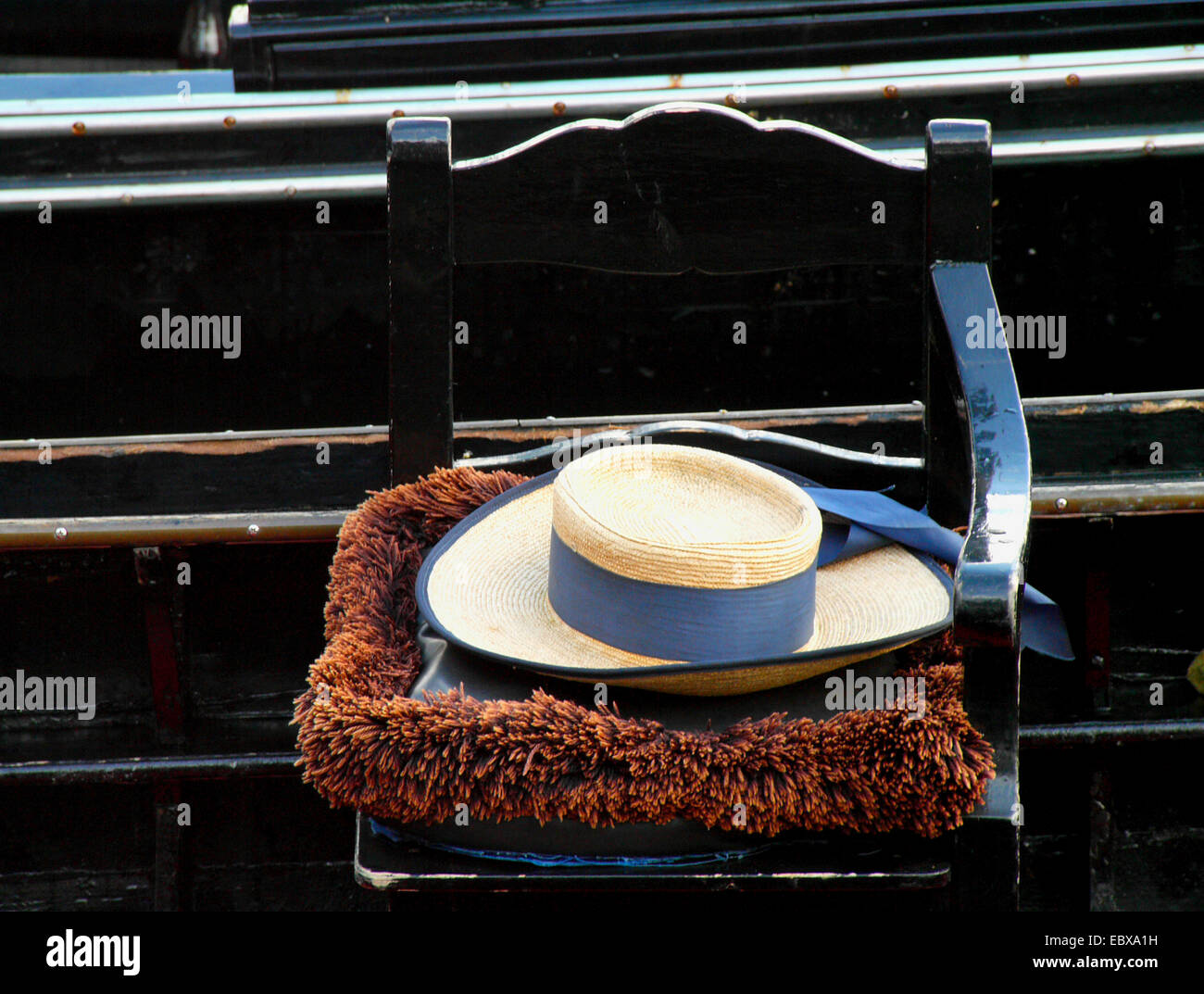 straw hat on a chair in a Venice gondola, Italy, Venice Stock Photo