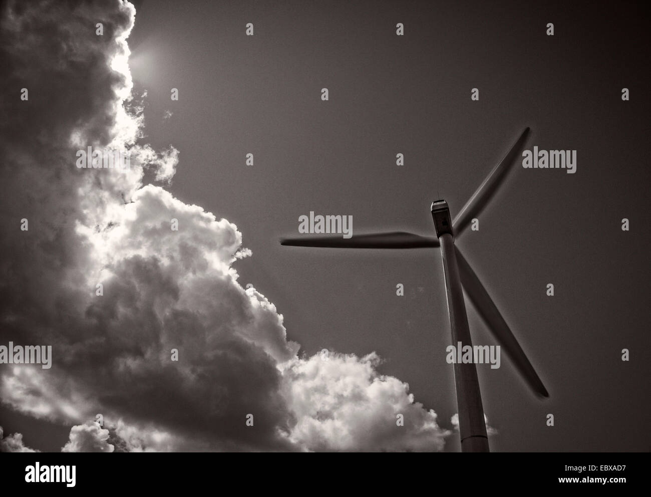 Rotor of a wind power plant and dramatic clouds. Stock Photo