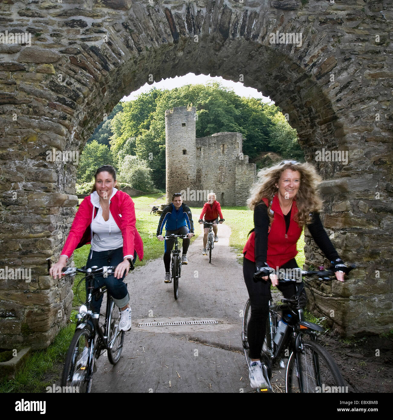bicyclists crossing a archway at Hardenstein Castle ruin, Germany, North Rhine-Westphalia, Ruhr Area, Witten Stock Photo