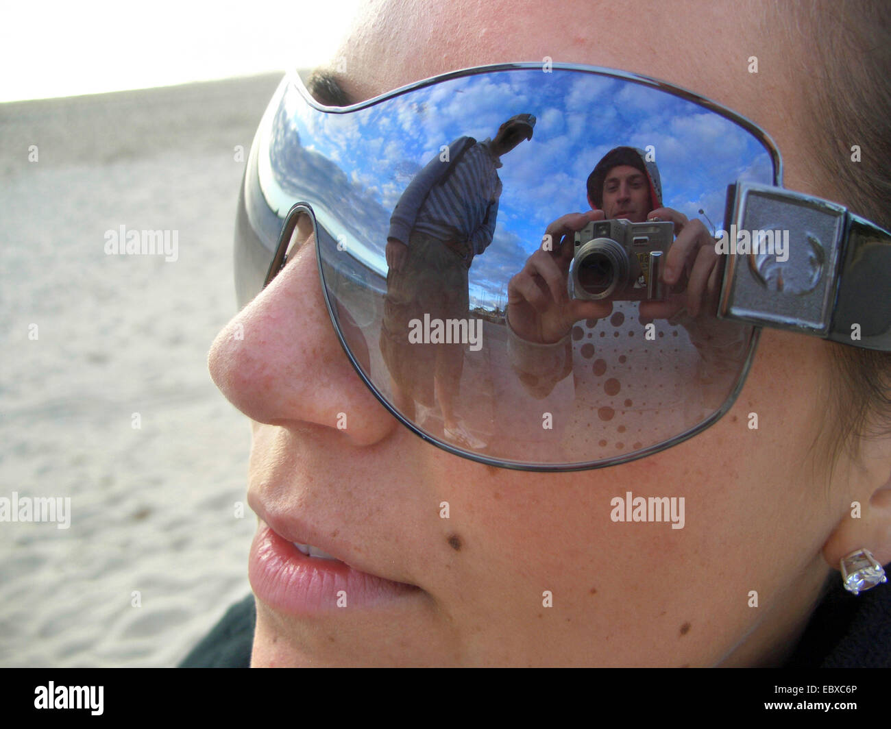 woman with sun glasses, photographer is reflected in the glasses, Australia, New South Wales Stock Photo