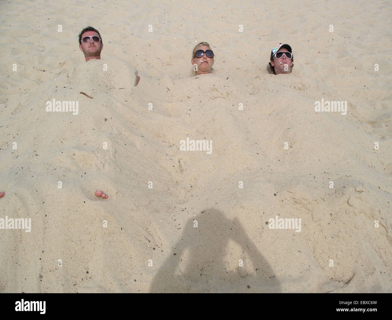 fun at the beach, woman and man filled up with sand, Australia, New South Wales Stock Photo