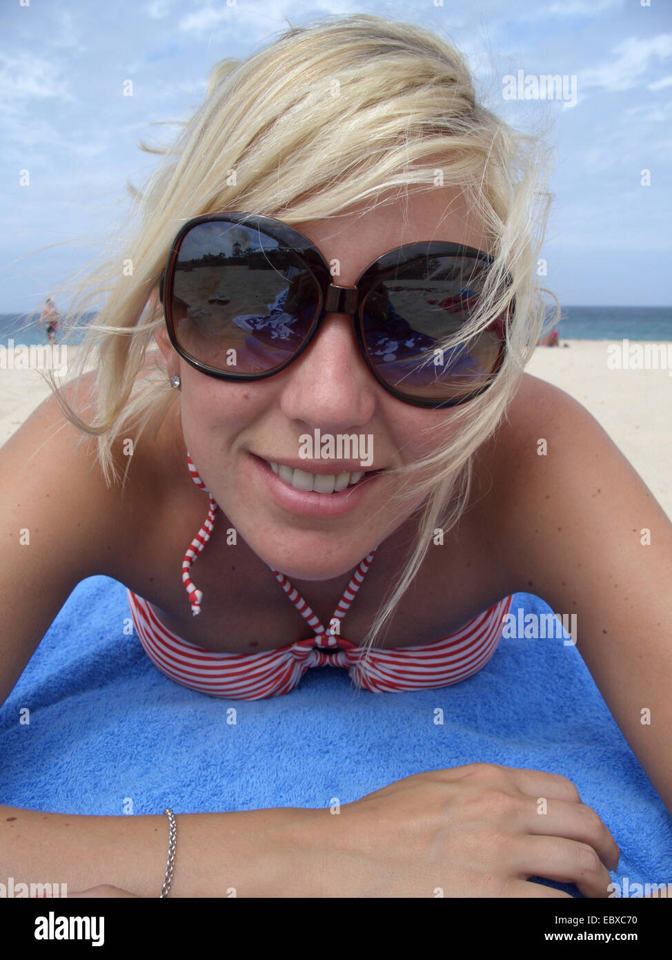 young woman with big sun glassses at the beach, Australia, New South Wales Stock Photo