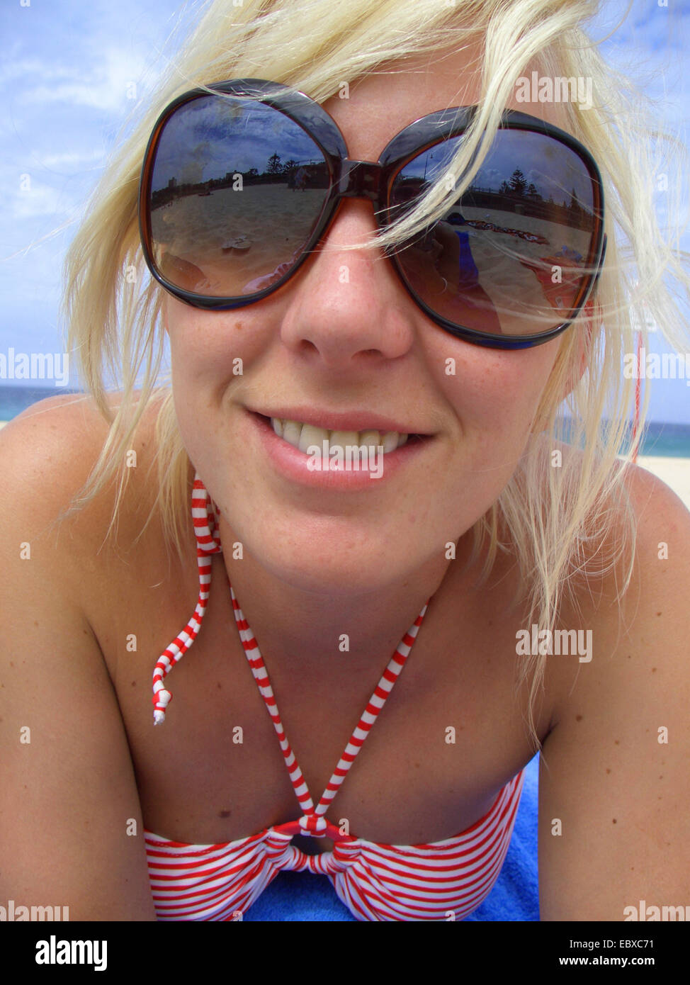 young woman with big sun glassses at the beach, Australia, New South Wales Stock Photo