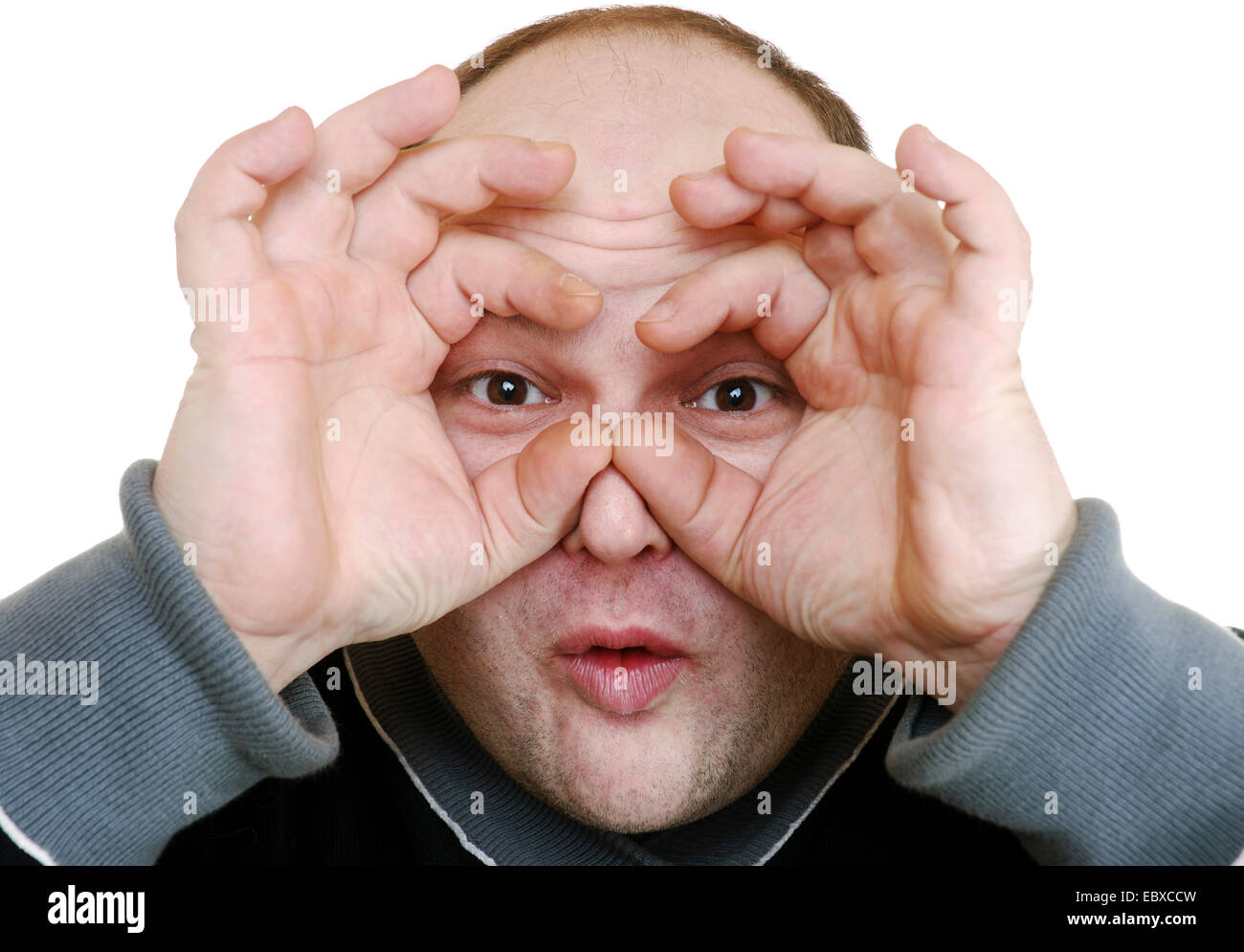 man making observe sign Stock Photo