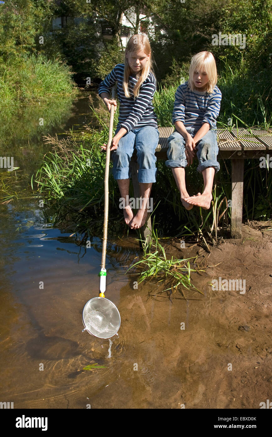 two childs with a selfmade brailer, made from a cullander Stock Photo