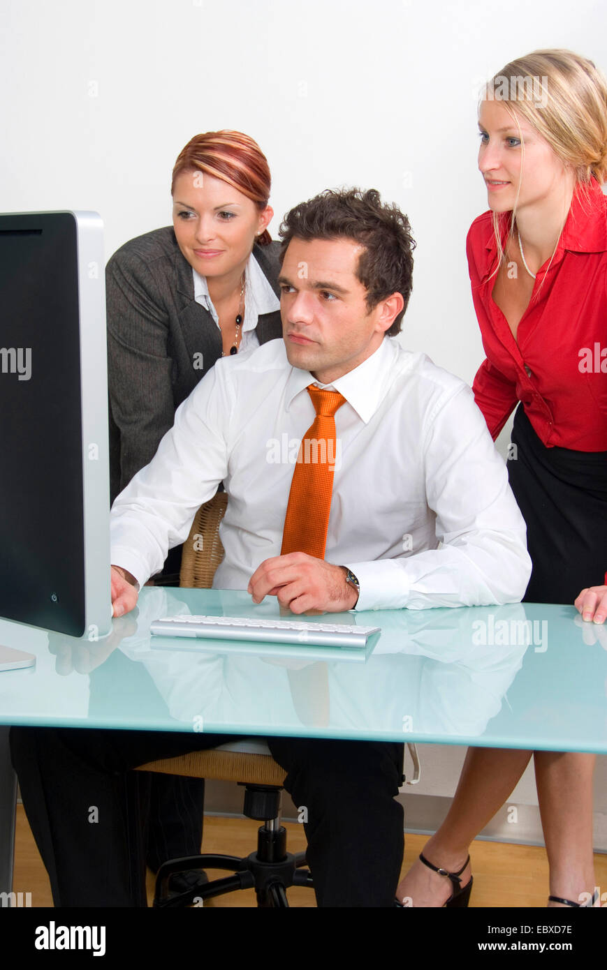 three young business people in office working on computer Stock Photo ...