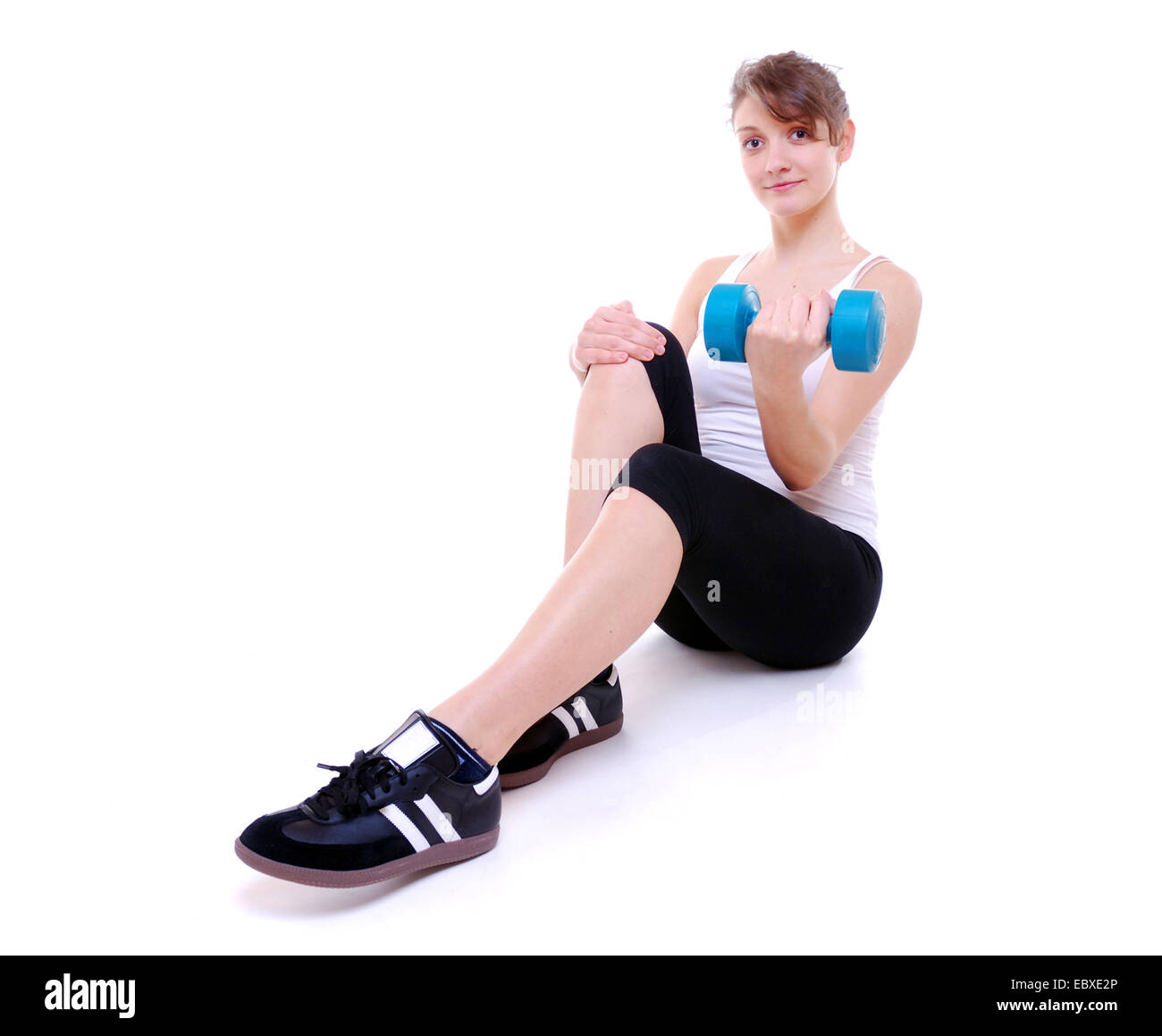 Young sportswoman with dumbbell Stock Photo