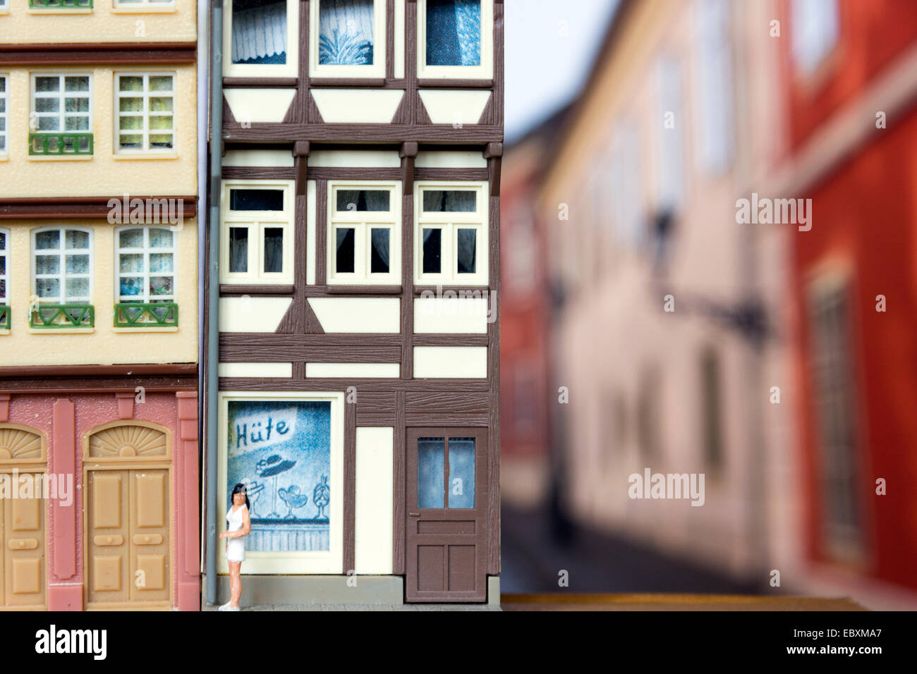 Close up of a model railway building, against a photograph of a street, still life Stock Photo