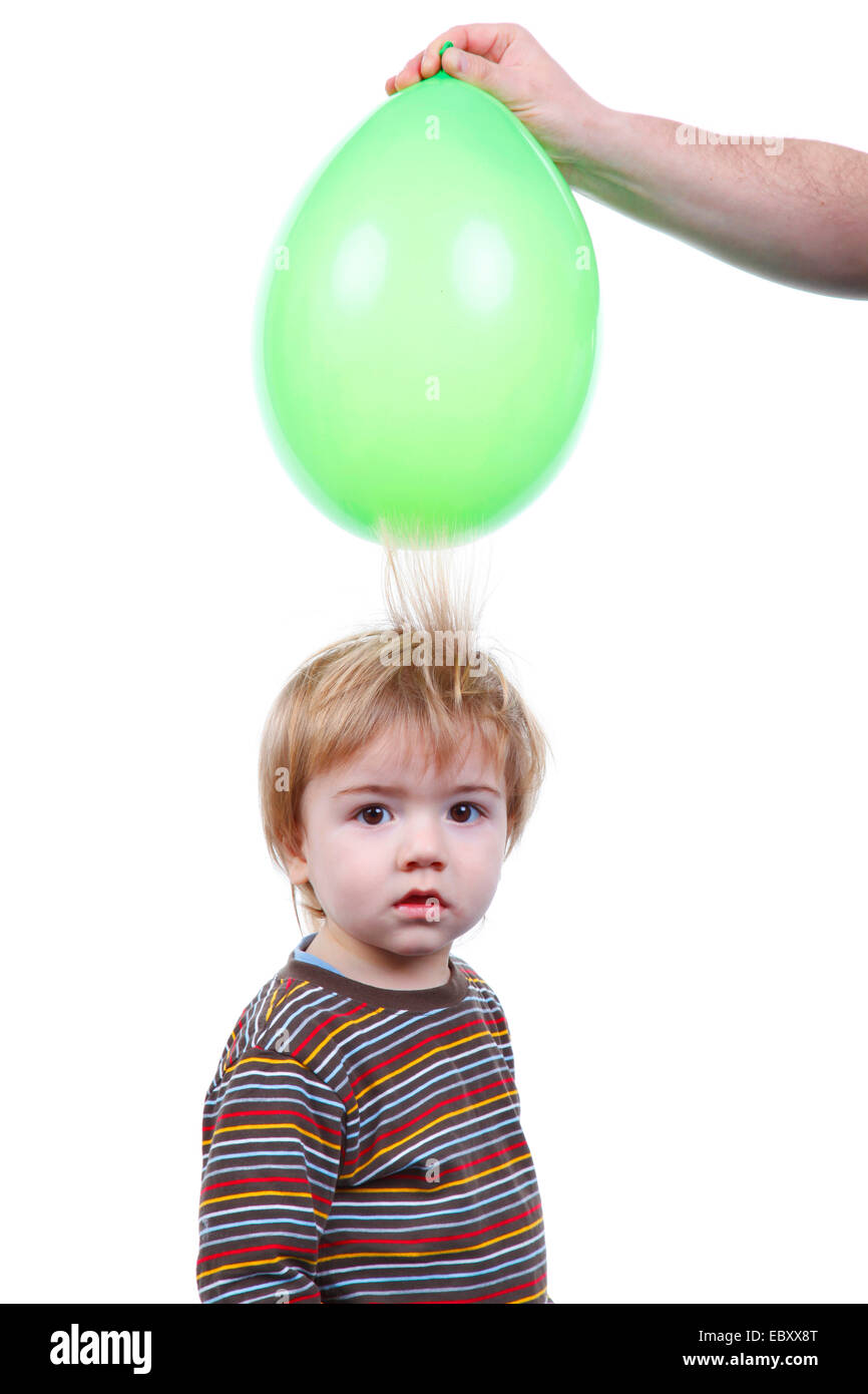 Little Boy S Hair Being Attracted By An Air Balloon Charged With