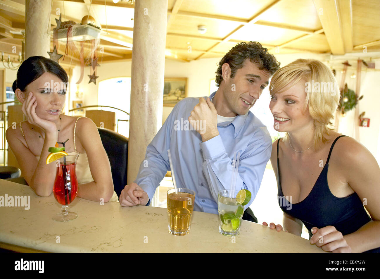 www.alamy.com/stock-photo-man-flirting-with-two-women-at-a-hotel-bar-jealou...