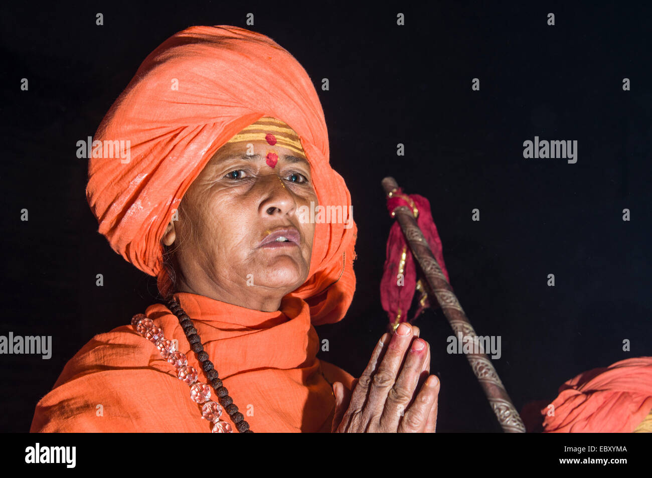 Newly initiated Shiva sadhvi, holy woman, from Avan Akhara, praying at night at the Sangam, the confluence of the rivers Ganges Stock Photo