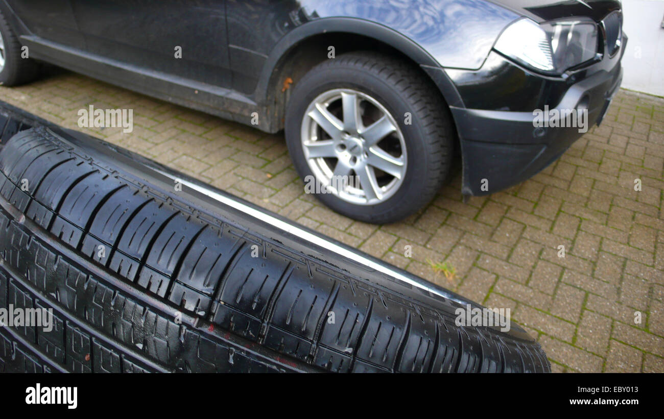 snow tire profile in front of a car, tire change Stock Photo