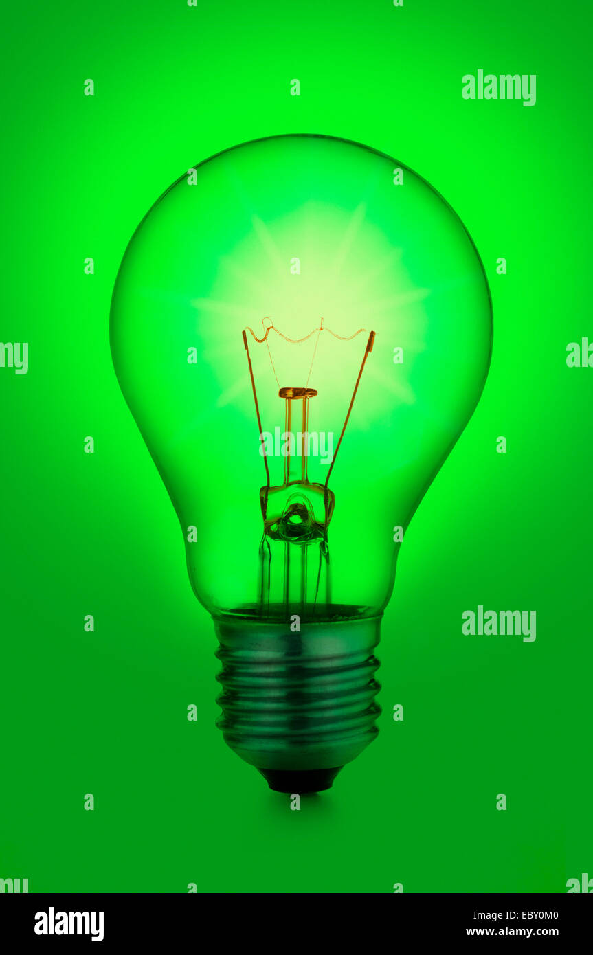 incandescent light bulb, on green background Stock Photo Alamy