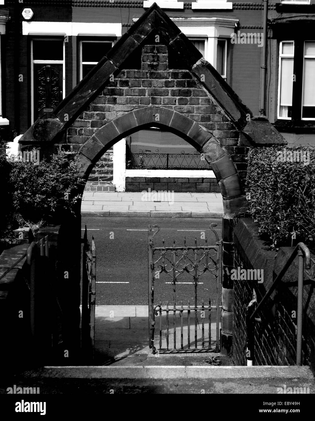 Stone church archway with gate. Stock Photo