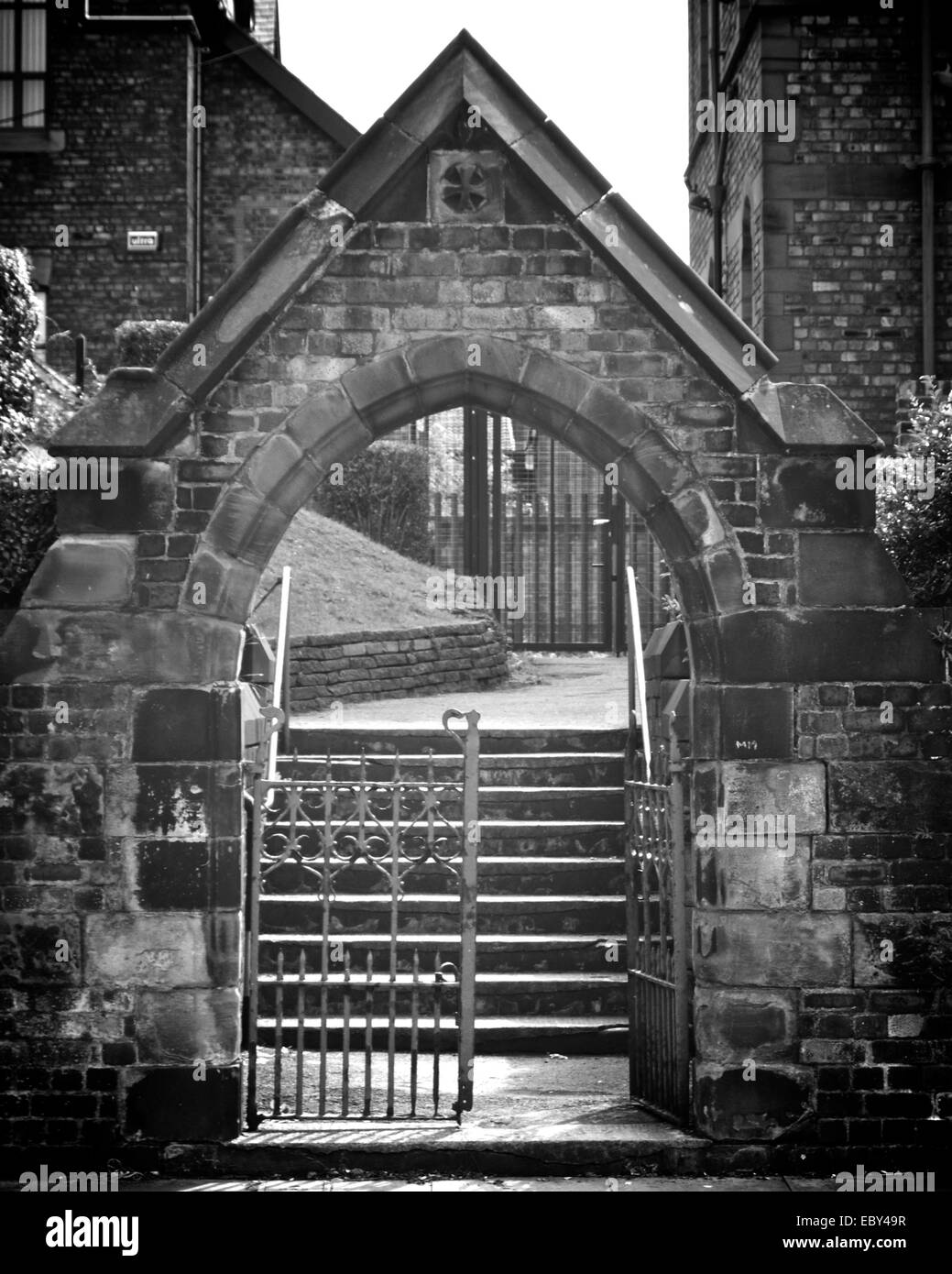 Stone church archway with gate. Stock Photo