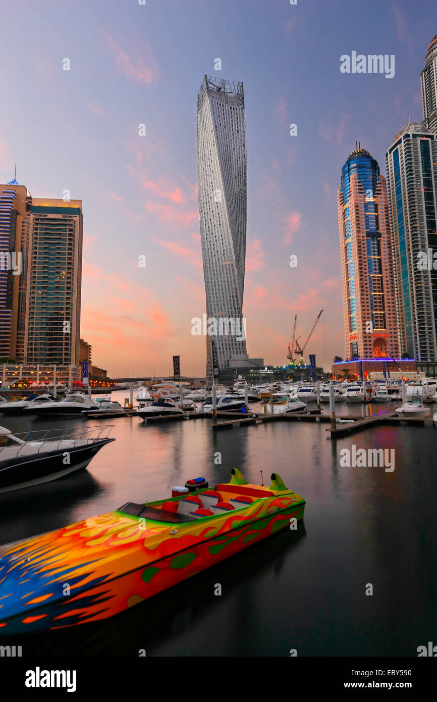 Dubai Marina skyline. Speed boat in front and twisted tower on the back. Stock Photo