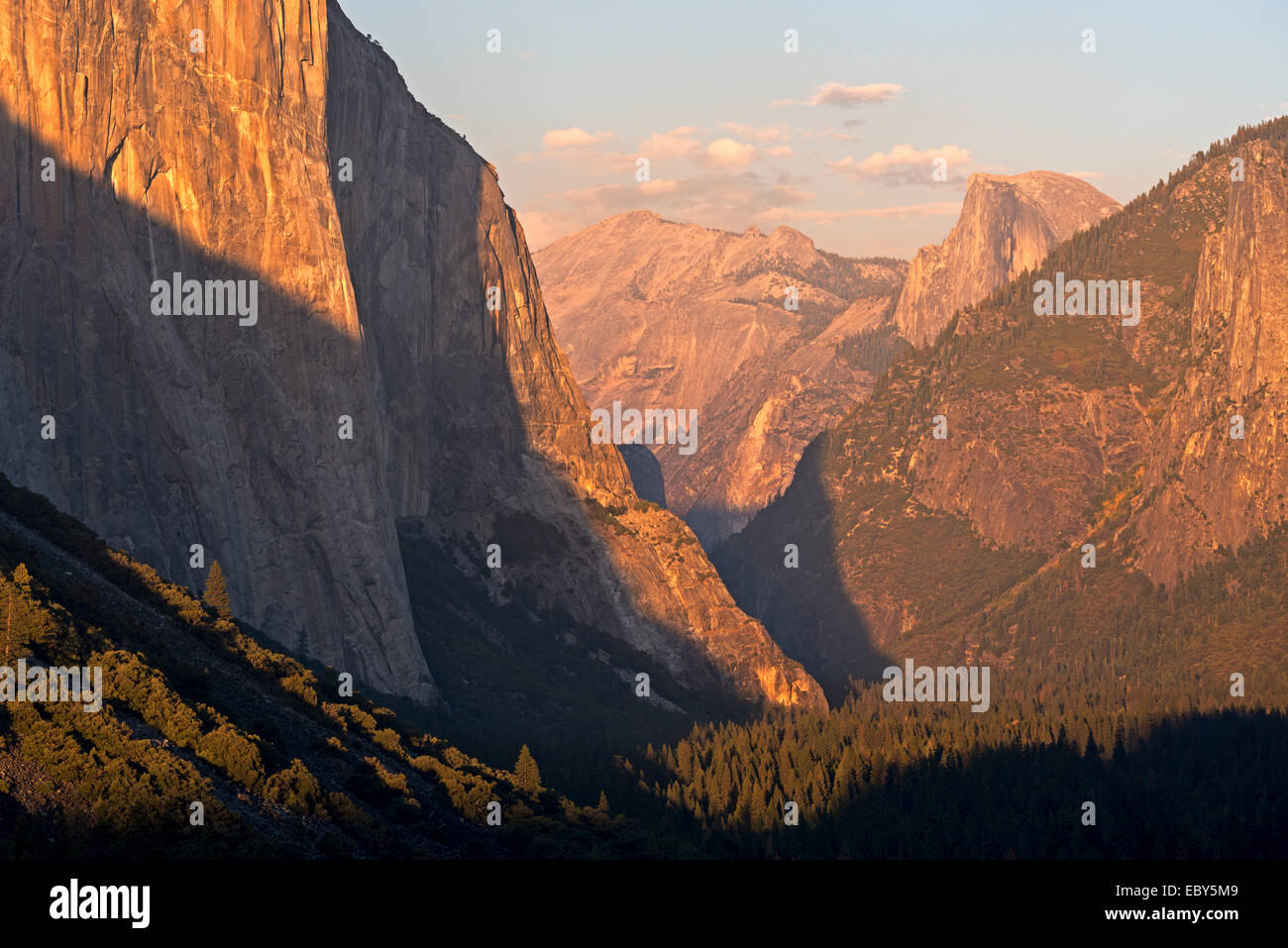Golden evening sunshine illuminates El Capitan and Half Dome in Yosemite Valley, California, USA. Autumn (October) 2014. Stock Photo