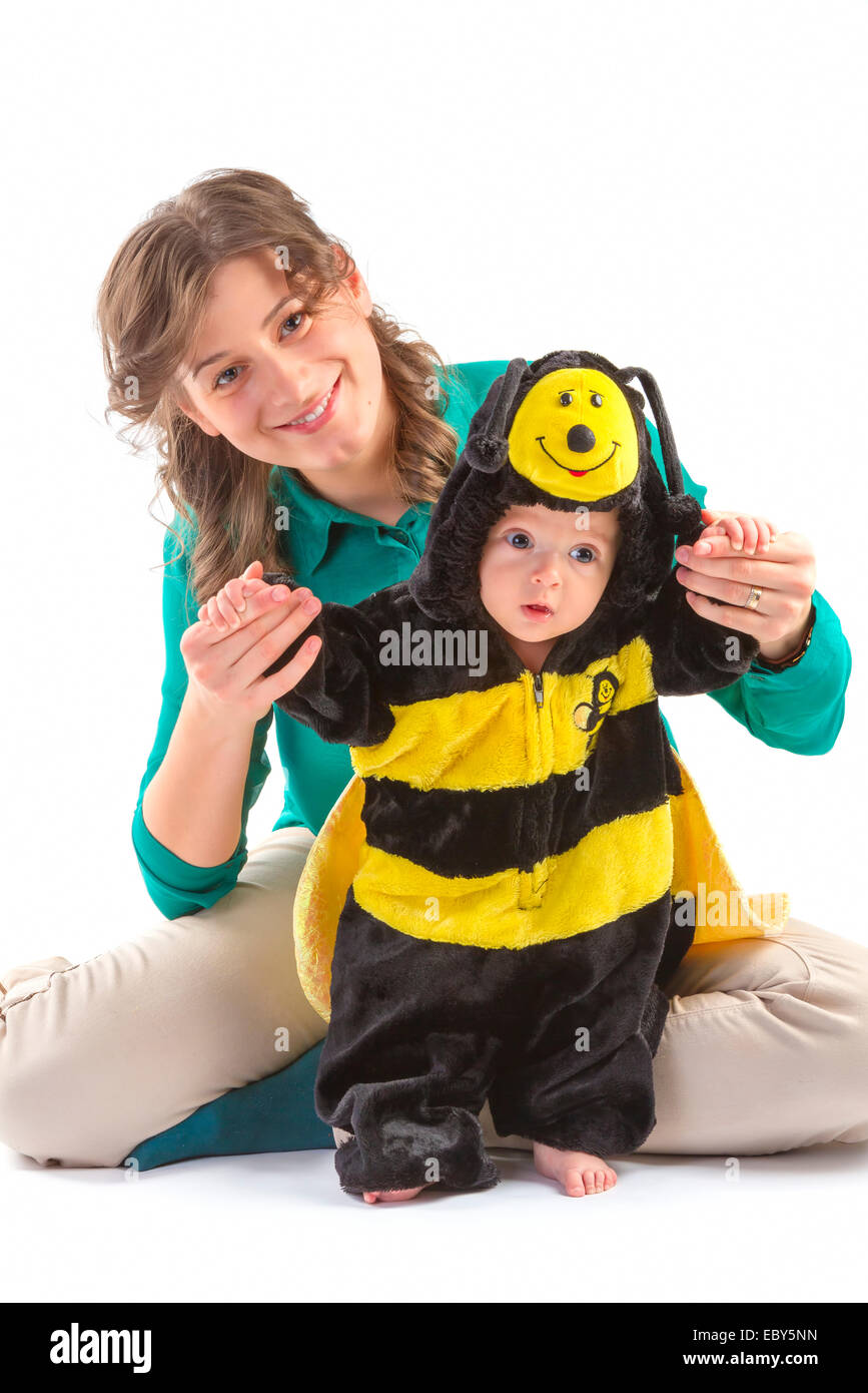 baby boy dressed up like bee with his mother on white background Stock Photo