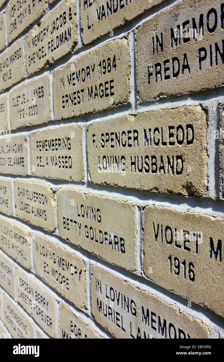 A wall of bricks with words carved on to them. Stock Photo