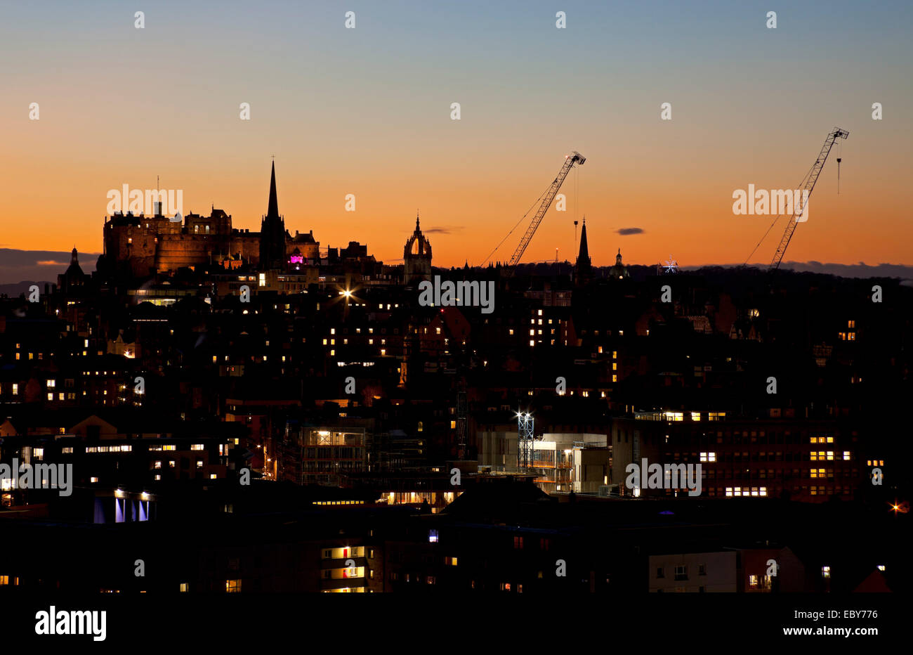 Edinburgh, Scotland, UK. 5th December, 2014. Edinburgh city centre had beautiful clear skies approaching dusk, as the temperature is forecast to drop to zero degrees or lower overnight in the city. Even construction cranes can look good when backlit with the afterglow of a setting sun. Stock Photo