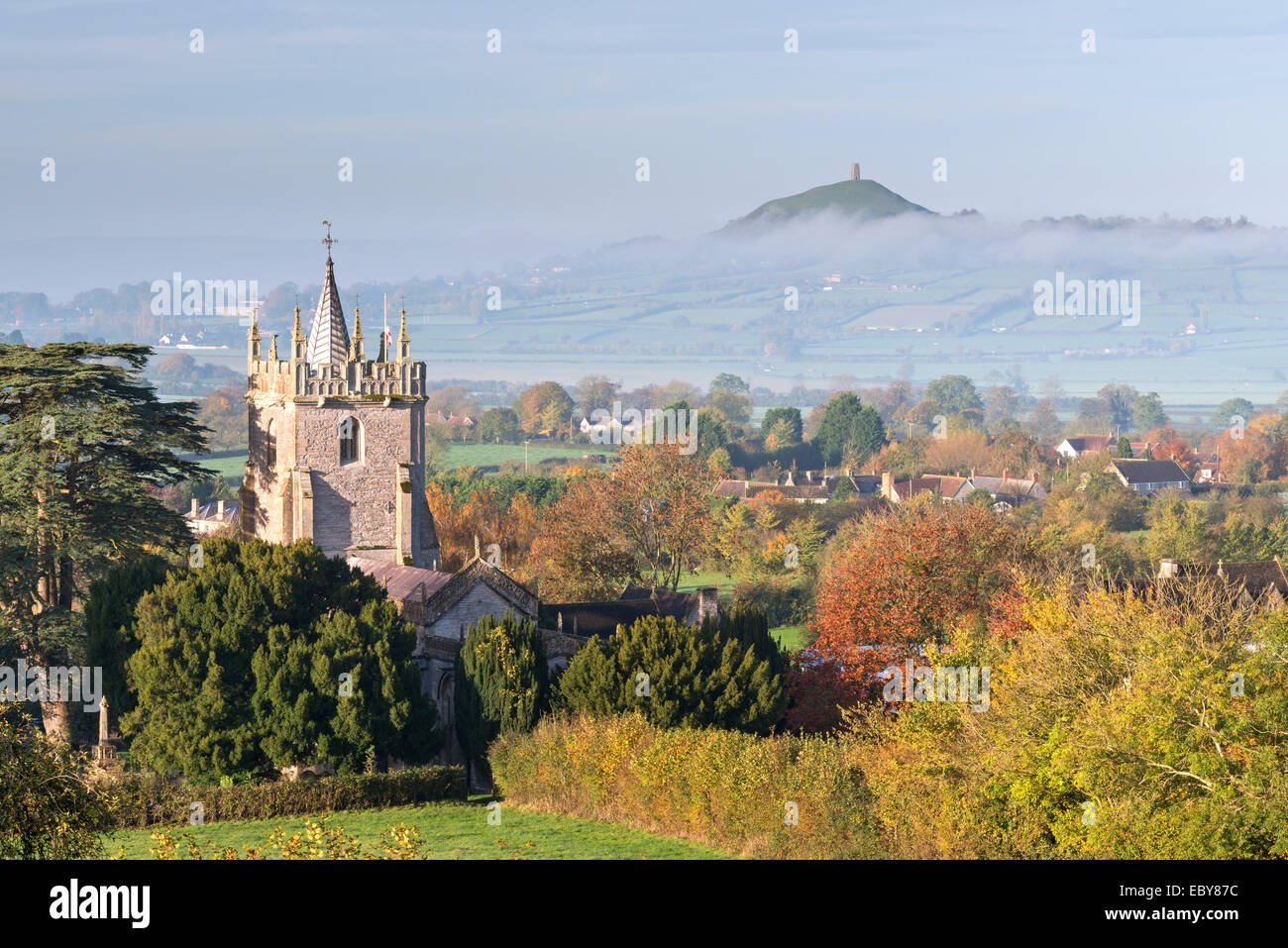 Glastonbury Tor and West Pennard Church on a misty autumn morning, Somerset, England. Autumn (November) 2013. Stock Photo