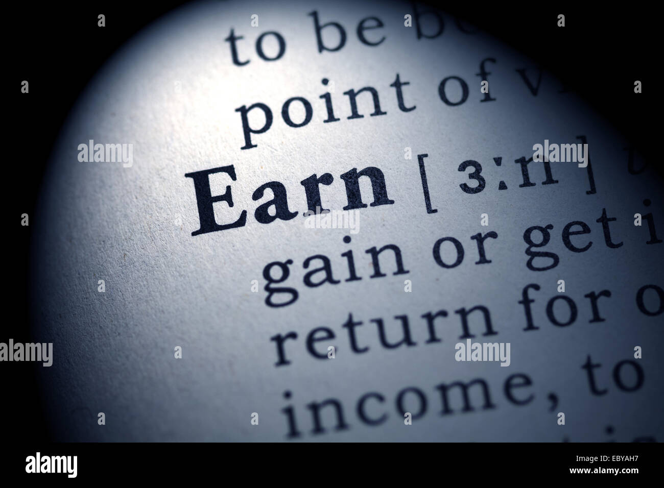 Fake Dictionary, Dictionary definition of the word earn. Stock Photo