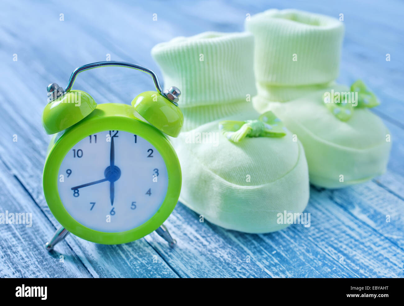clock and baby socks Stock Photo Alamy