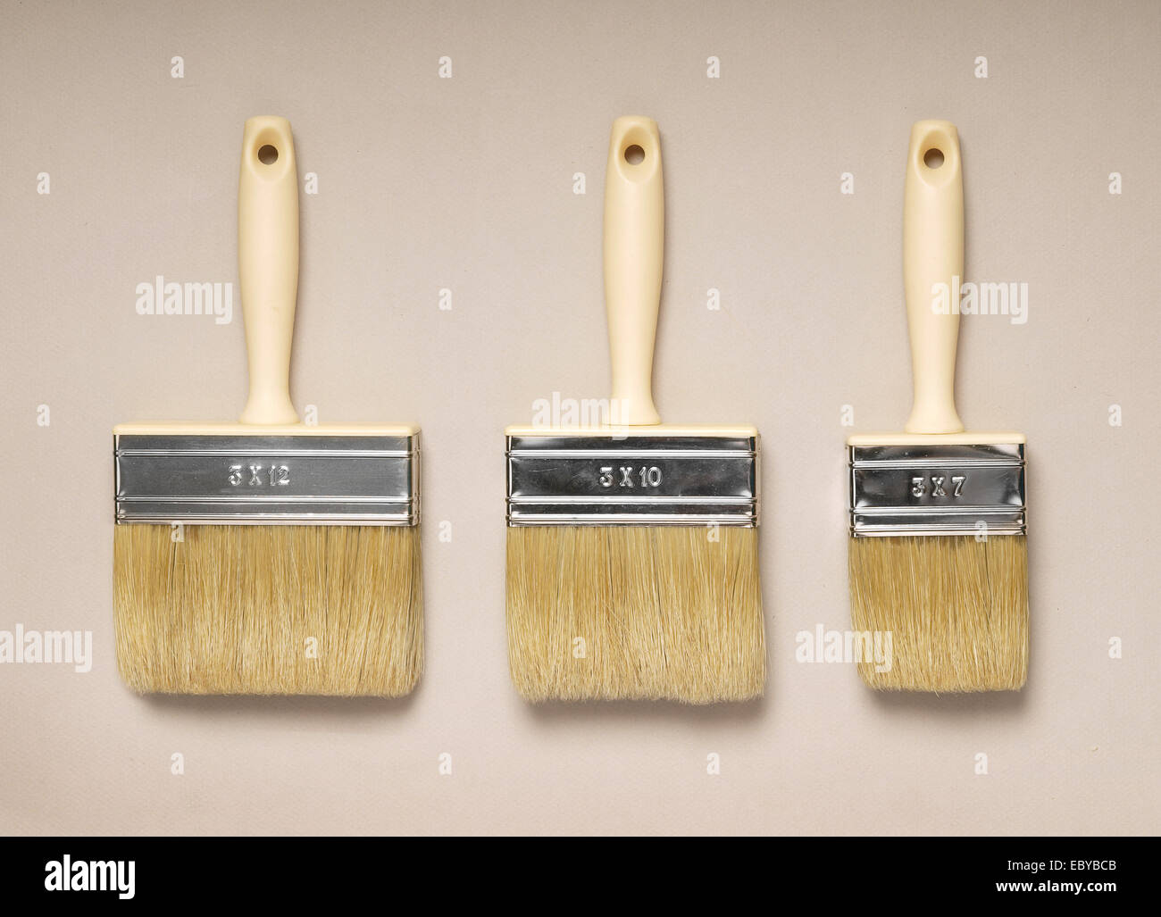 Three painting brushes with wooden handles Stock Photo Alamy