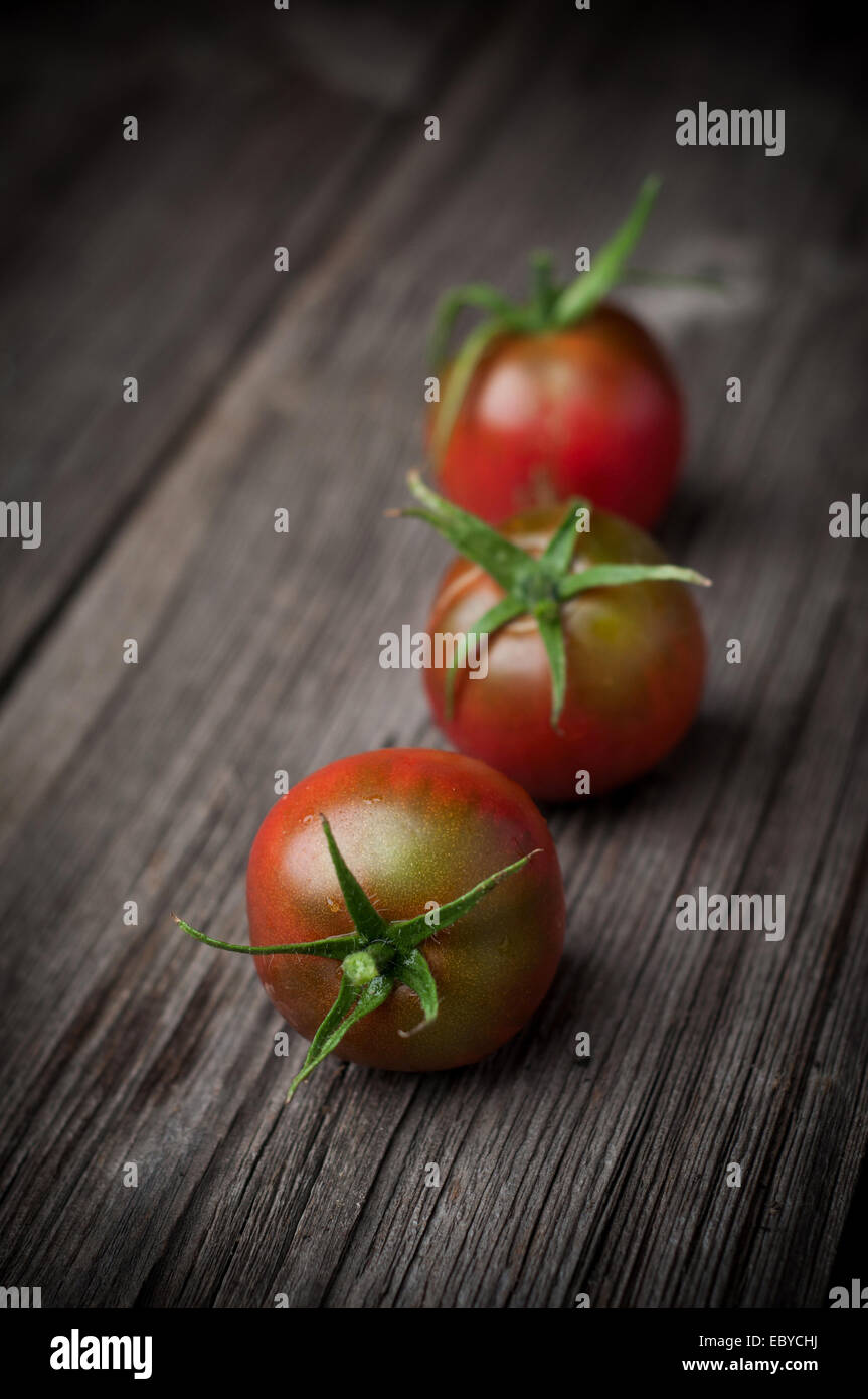 Ripe tomatoes on wooden table, low depth of focus Stock Photo - Alamy