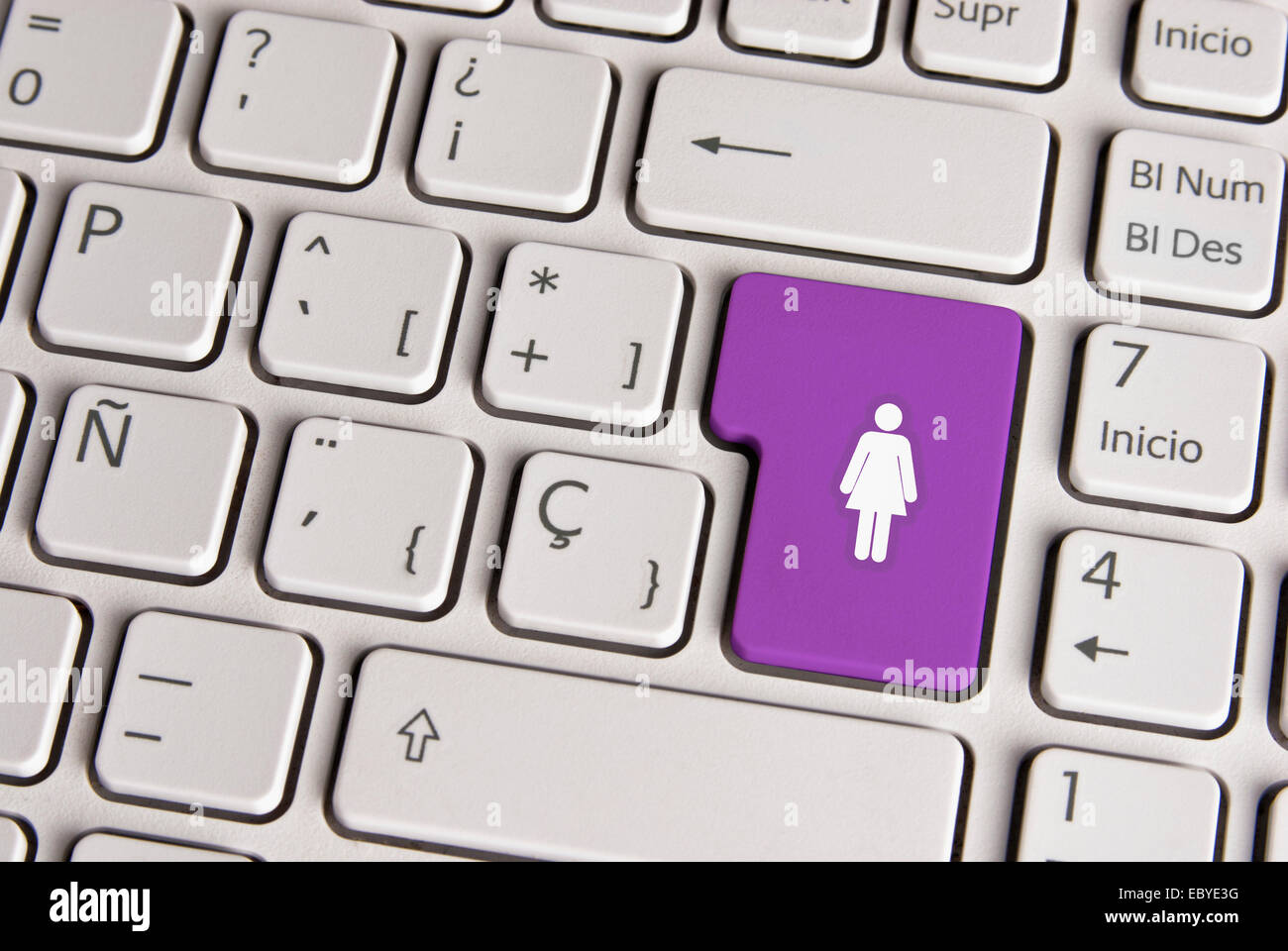 Spanish keyboard with female gender women figure icon over purple background button. Image with clipping path for easy change th Stock Photo