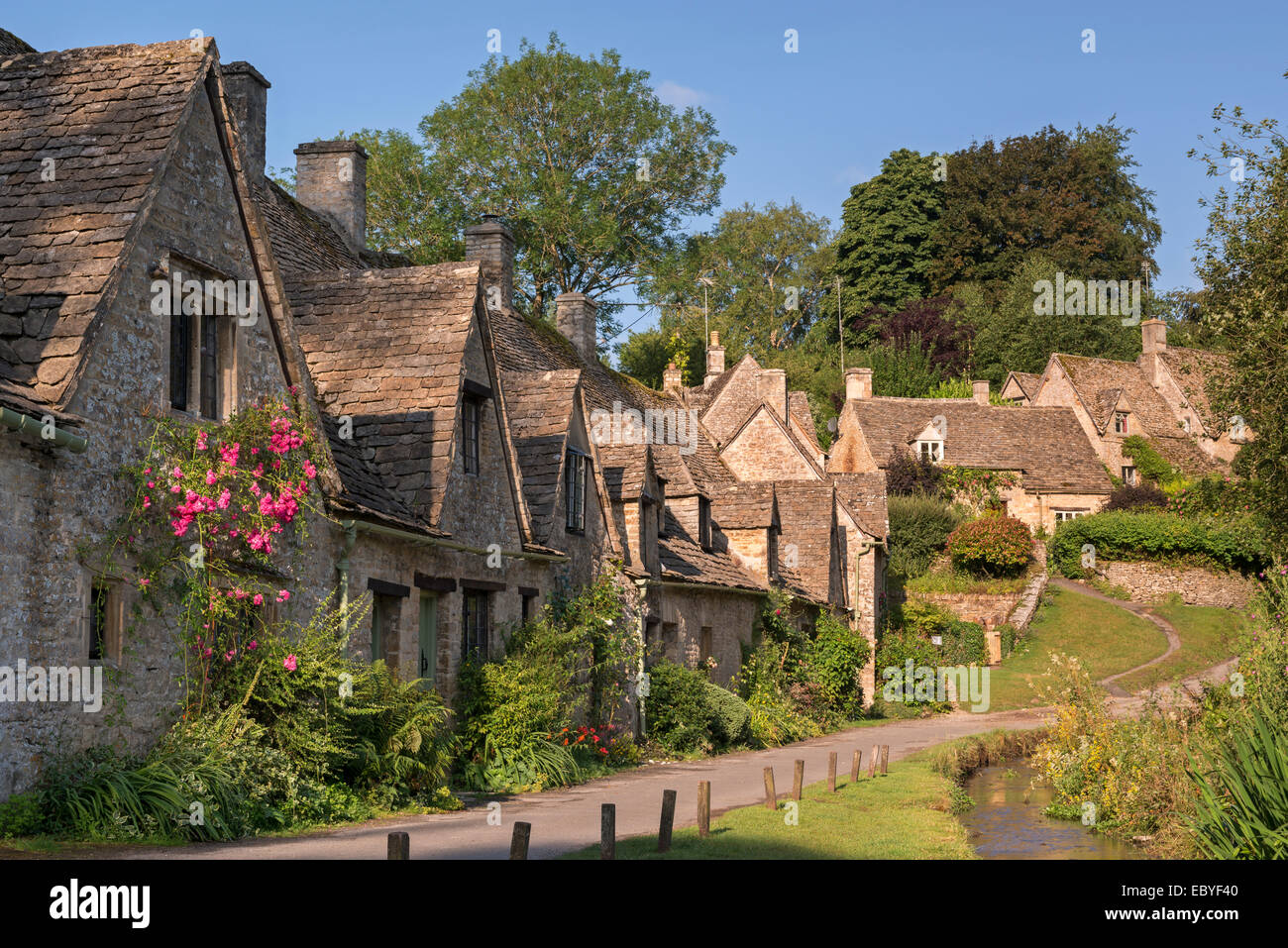 Pretty cottages at Arlington Row in the Cotswolds village of Bibury, Gloucestershire, England. Summer (July) 2014. Stock Photo