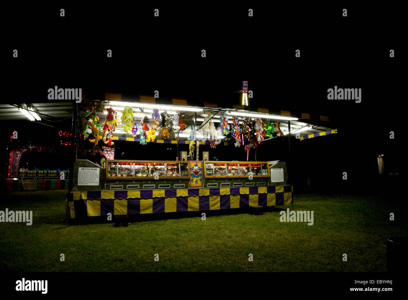 Night shot of a colorful game attraction at a county fair. Stock Photo
