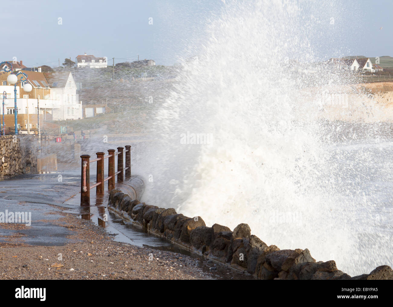 waves crashing against sea wall at Freshwater bay, Isle of Wight Stock