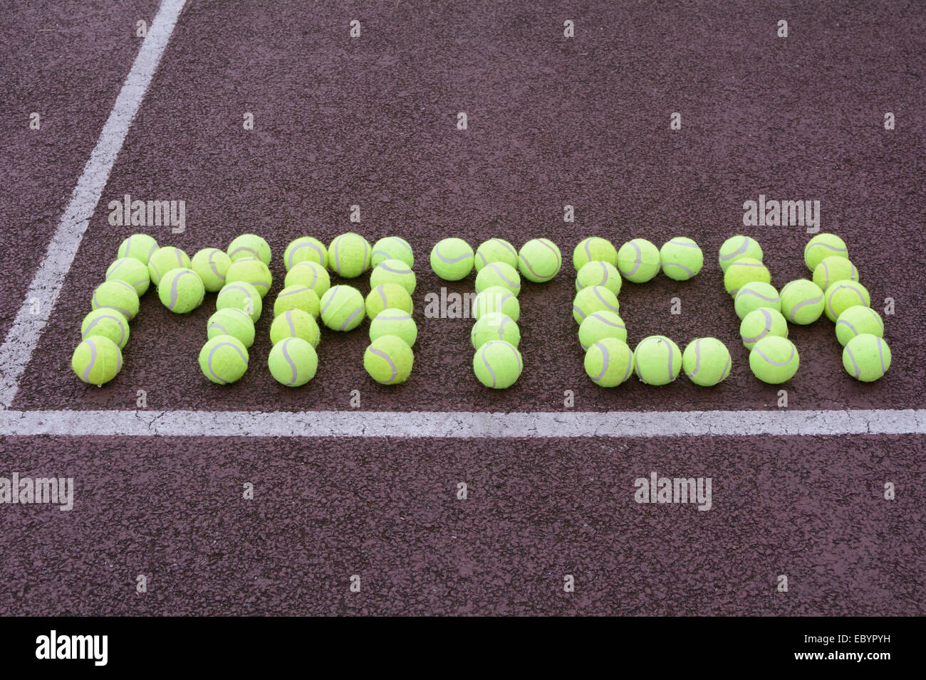 Tennis match made from tennis balls on hard court Stock Photo