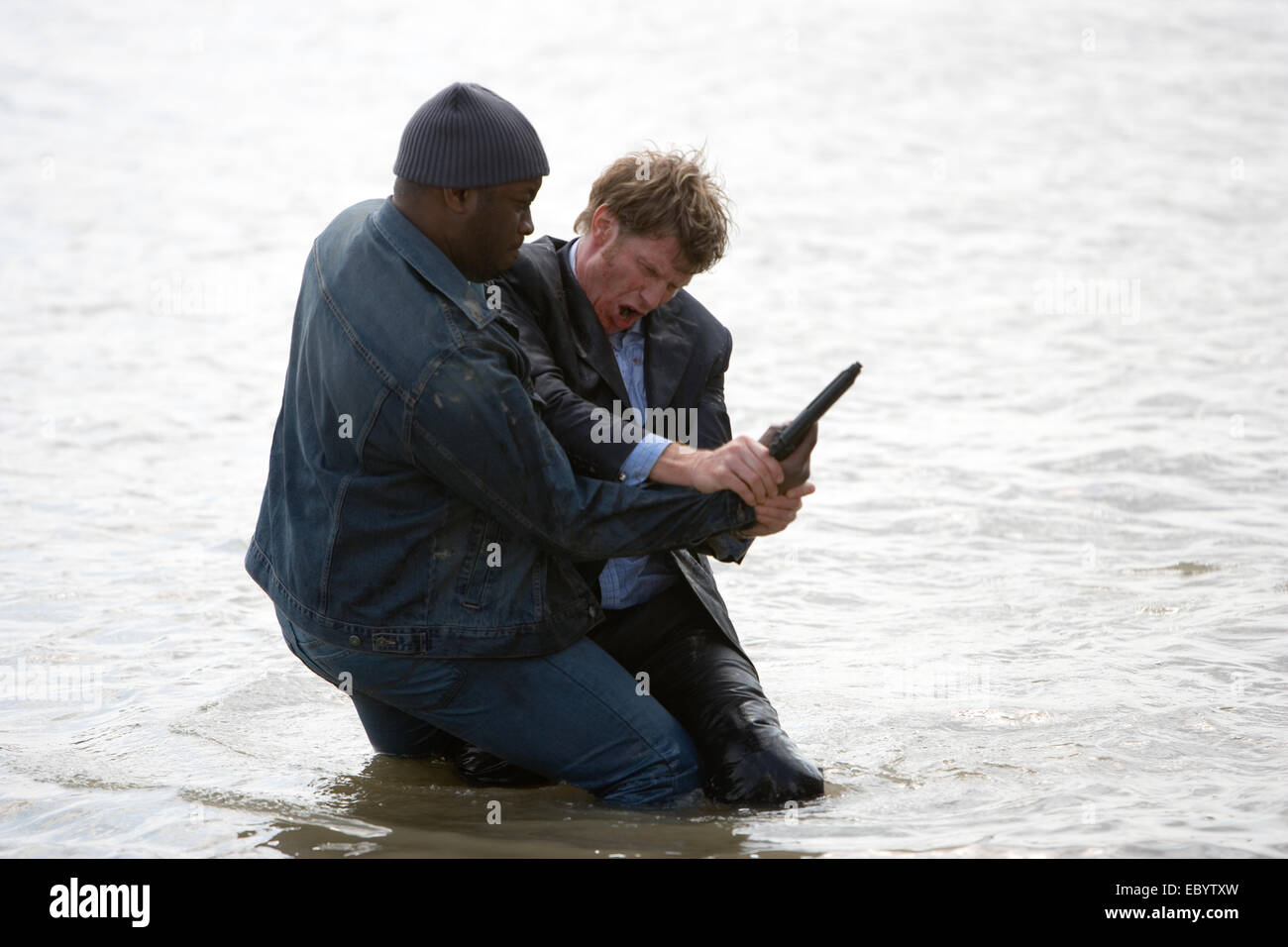 Mark Ashante Jason Flemyng, (right)in a fight scene during filming of 'The Riddle' Stock Photo