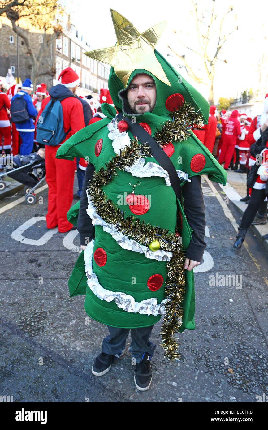 Participant in a Christmas tree costume during the parade. Some five  hundred participants dressed in various Christmas costumes passed through  the center of Ukrainian capital with live music and fireworks. Costume  parades