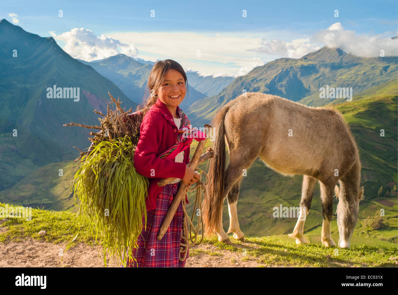 A young Quechua shepherd girl with her horse in the Andes Mountains of