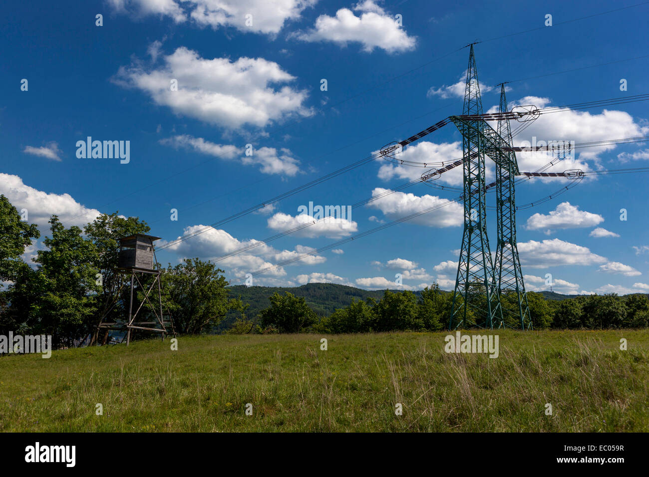 Electricity pylon, clouds on a blue sky background Czech Republic Stock Photo