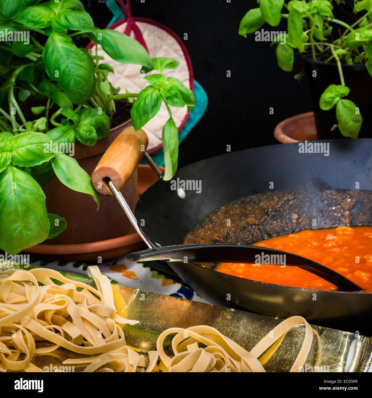 Fettuccine or tagliatelle cut ready to cook and sauce bolognese Stock Photo