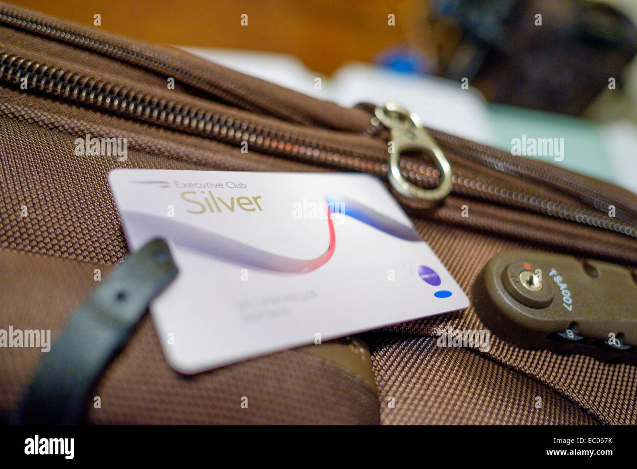 A Silver frequent flyer Executive Club card from British Airways attached to a suitcase. Stock Photo