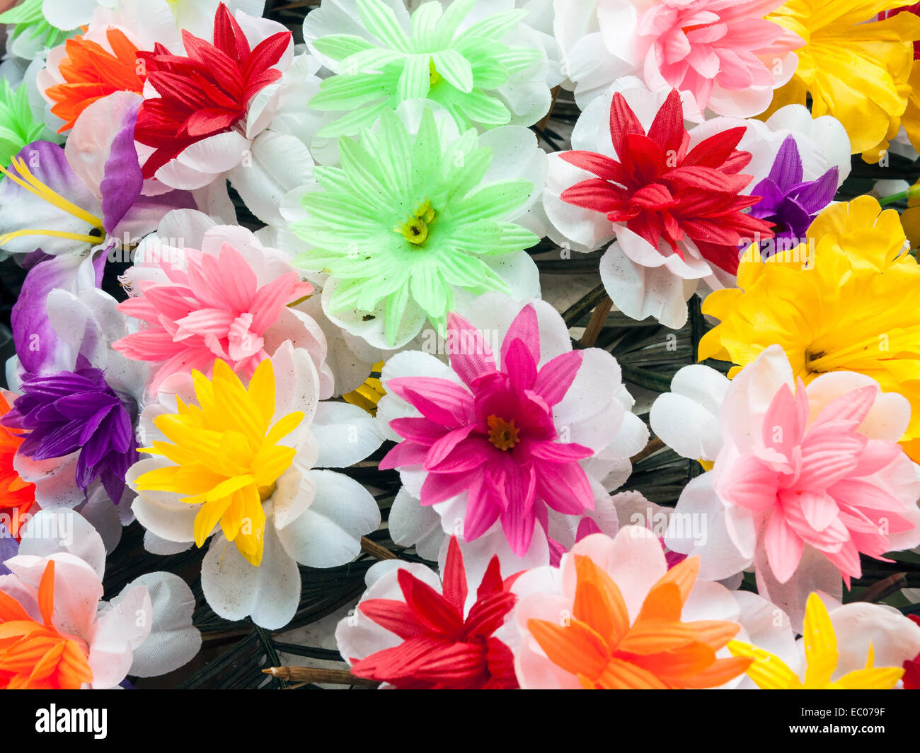 Dirty artificial flowers for decoration the vertical garden Stock Photo
