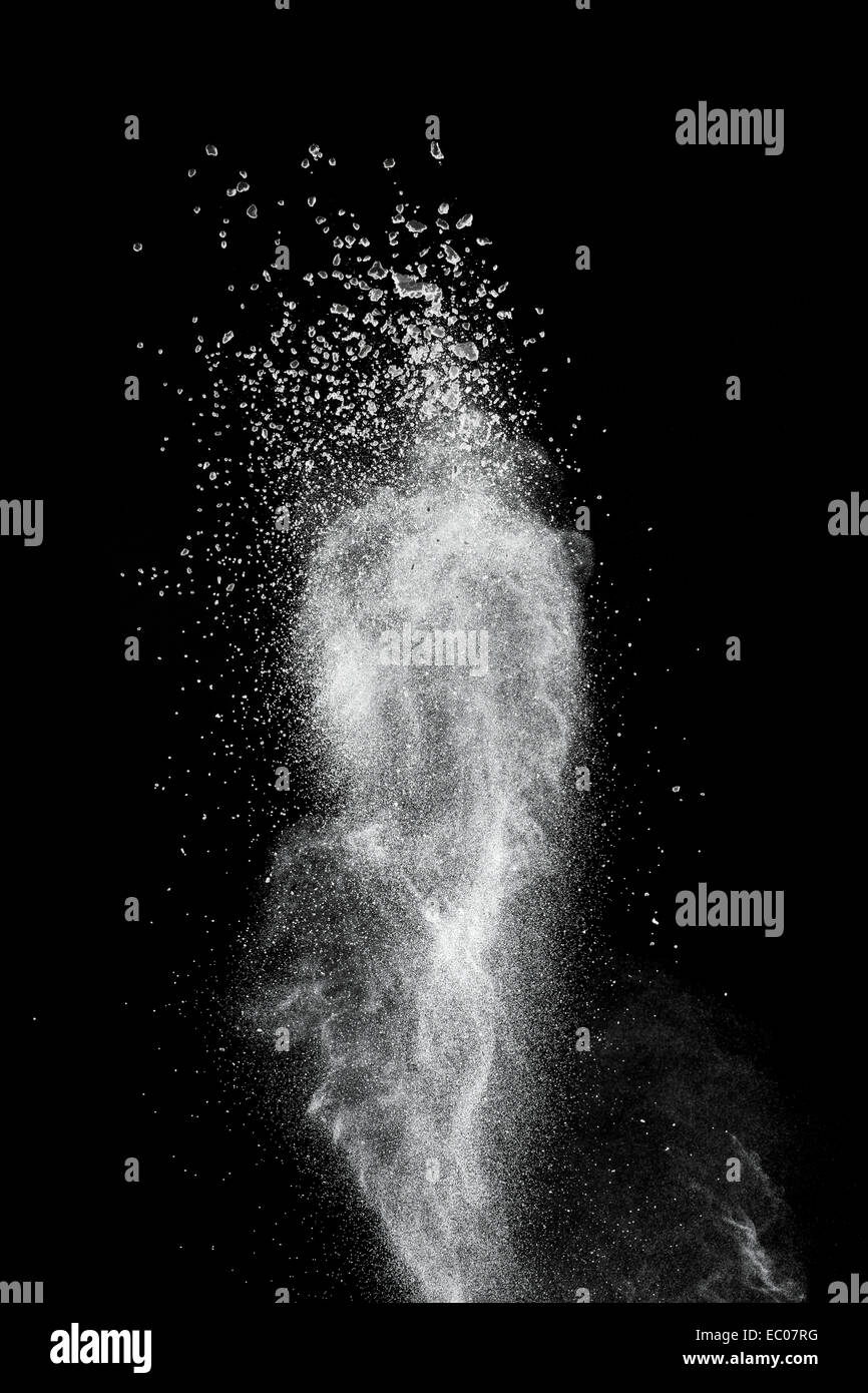White powder explosion isolated on black background Stock Photo - Alamy