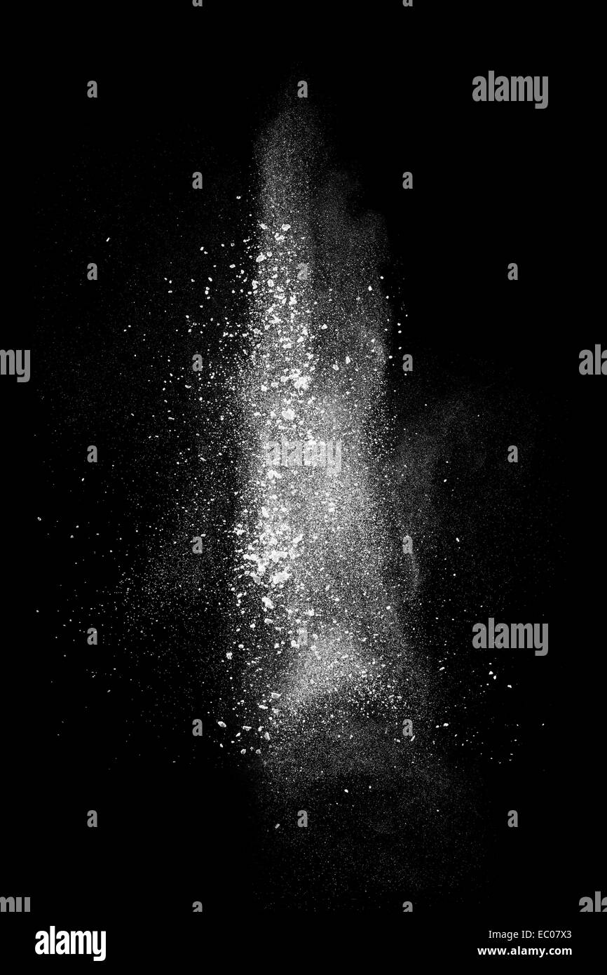 White powder explosion isolated on black background Stock Photo - Alamy