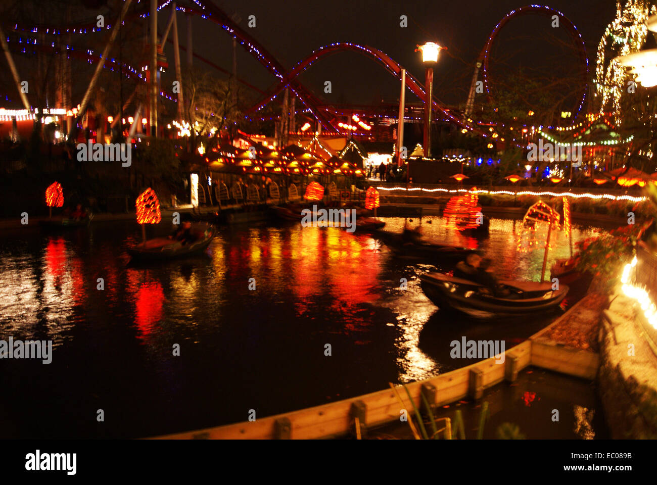 Red lights from the boats of at Tivoli pleasure gardens reflecting on the lake Stock Photo