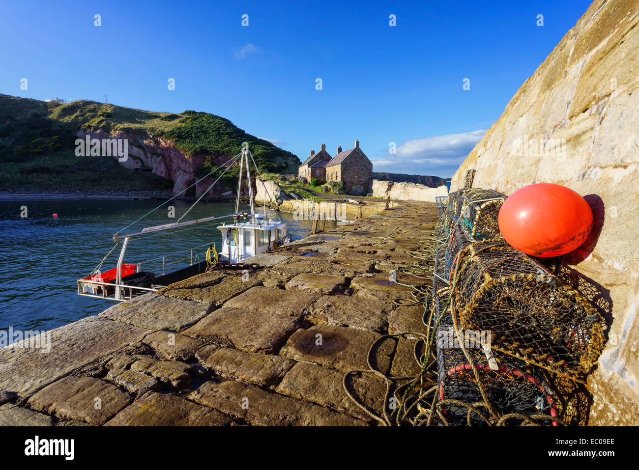 The seawall and fishing boats in the small, historic Cove Harbour