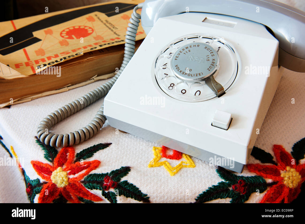 Telephone in preserved GDR-era apartment, pre 1989 fall of the wall.  Note emergency numbers on telephone for Volkspolizei etc. Stock Photo