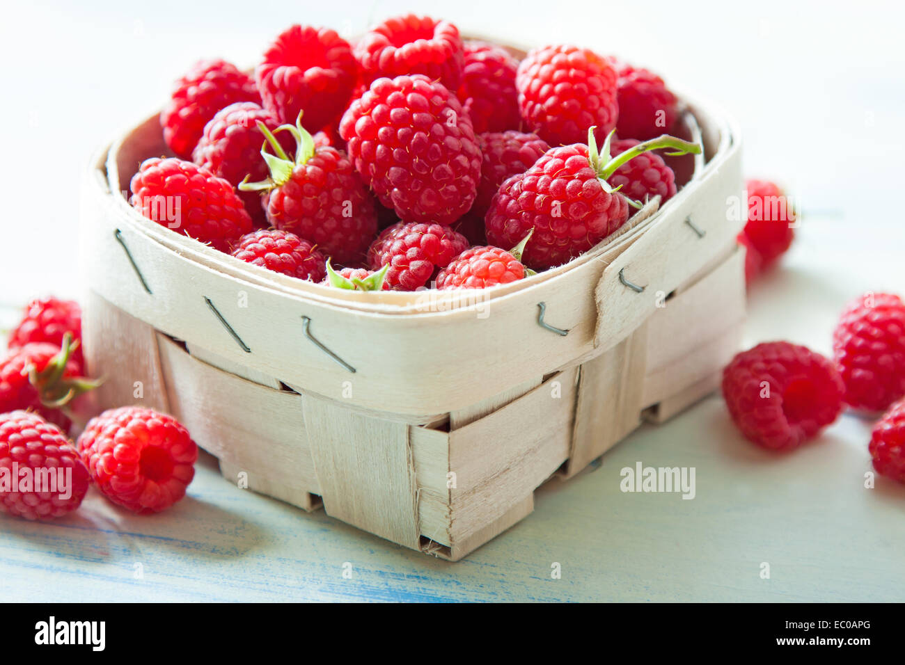 Ripe raspberries in small basket. Center focus, thin depth of field Stock Photo