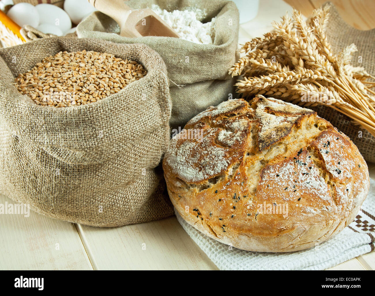 Homemade bread and wheat grain on table Stock Photo