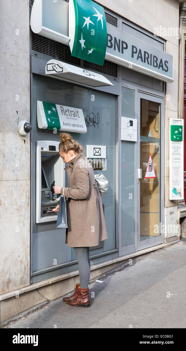 person woman withdrawing money cash machine bank Stock Photo