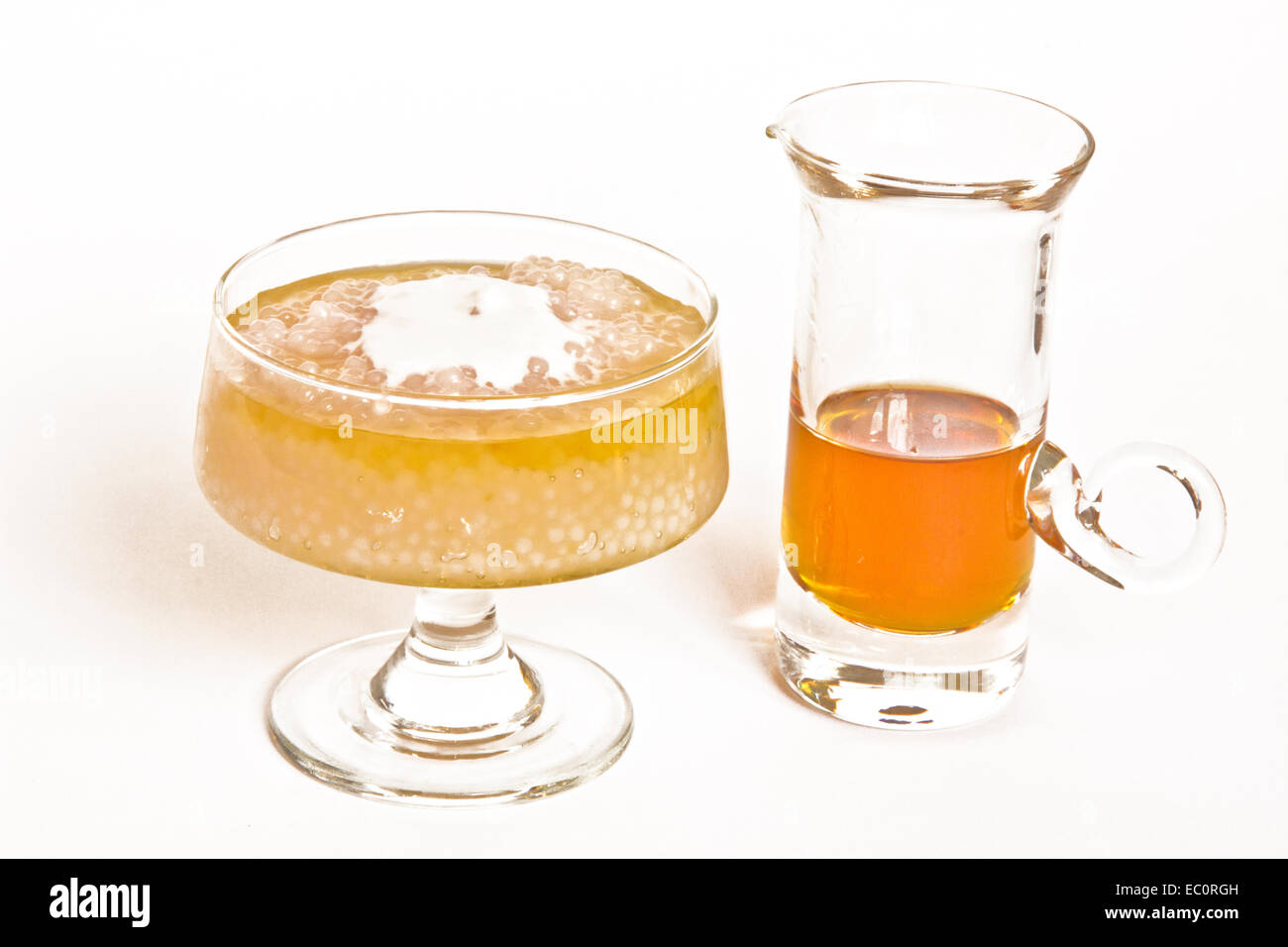 Gula Malacca, a Malaysian dessert with coconut cream in a glass dish and accompanying palm sugar syrup. Stock Photo